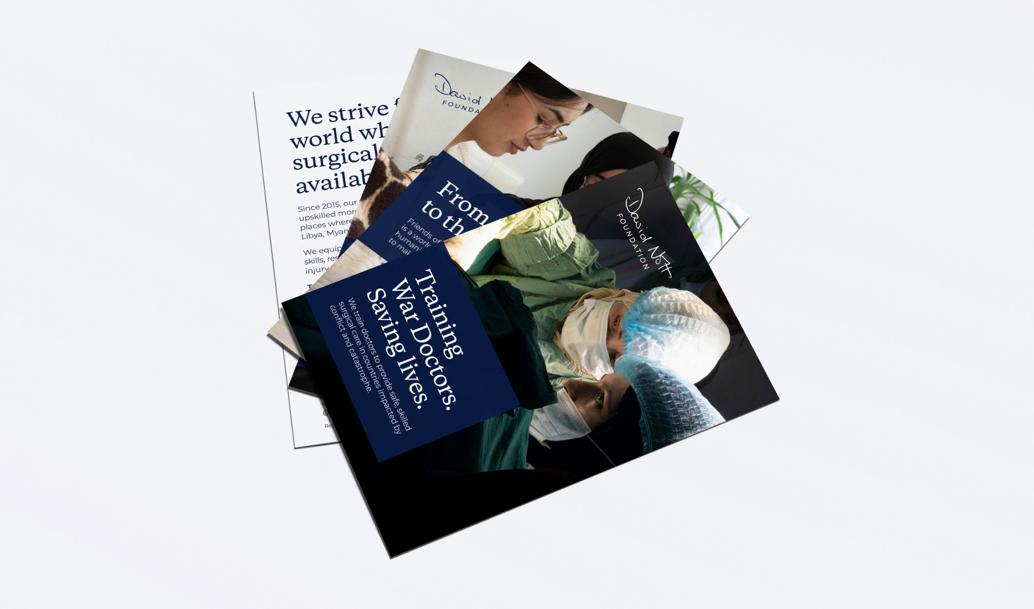 A fan of David Nott Foundation flyers, including ‘Training war doctors. Saving lives.’ over a photo of surgeons operating