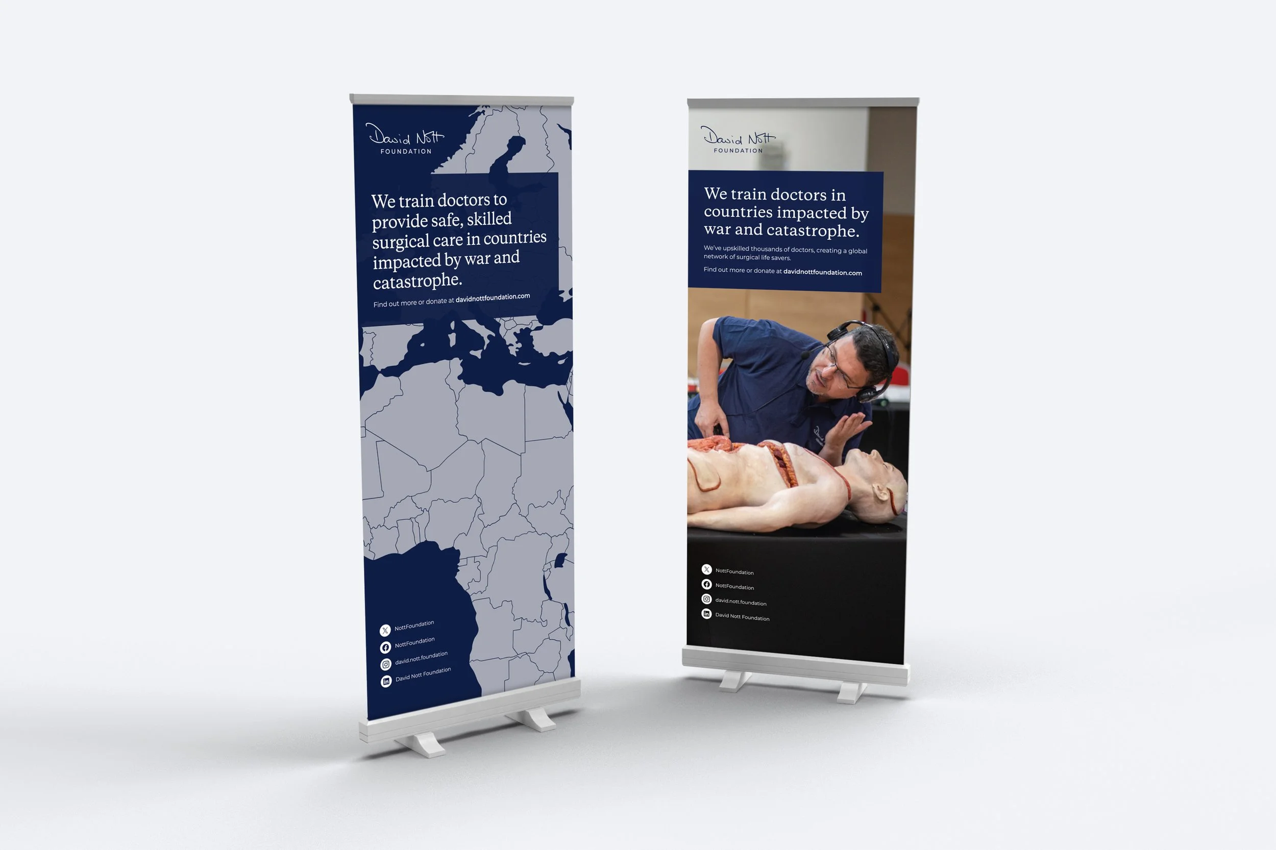 Two David Nott Foundation pull-up banners with map outlines, one with a photo of a surgeon training on a simulator
